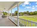Covered porch offers a view of the lush front lawn and the peaceful neighborhood at 189 Lochshire Ln, Woodleaf, NC 27054