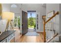 Bright entryway featuring hardwood floors, an open door to the lush outdoors, and a staircase at 2019 Lynmore Dr, Sherrills Ford, NC 28673