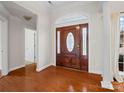 Welcoming foyer with a wooden front door and gleaming hardwood floors at 2872 Wheat Field Ct, Lincolnton, NC 28092