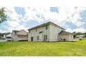 Large, well-maintained backyard with lush green grass and a view of the house's rear facade at 3043 Streamlet Way, Monroe, NC 28110