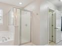 Bathroom featuring a glass enclosed shower with a tub and a bright, neutral color palette at 3043 Streamlet Way, Monroe, NC 28110