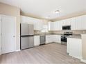 Spacious kitchen with stainless steel appliances and white cabinets at 3043 Streamlet Way, Monroe, NC 28110
