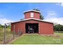 Large red outbuilding with ample storage space for vehicles or equipment at 3451 Greene Rd, Monroe, NC 28110