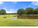 Picturesque pond surrounded by lush greenery, creating a serene and private setting at 3451 Greene Rd, Monroe, NC 28110