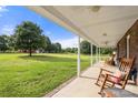 Inviting porch with rocking chairs, offering a relaxing space to enjoy the beautiful landscape at 3451 Greene Rd, Monroe, NC 28110