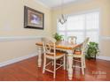 Bright dining room with hardwood floors, white trim and a traditional chandelier at 3697 Travertine Dr, Lancaster, SC 29720