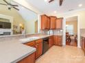 Open kitchen showcasing wood cabinetry, neutral countertops and a seamless transition to the dining area at 3697 Travertine Dr, Lancaster, SC 29720