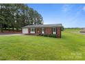 Lovely brick home with green lawn, mature trees, and a welcoming front porch at 522 Ne Connector Hwy, Albemarle, NC 28001