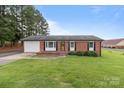 Traditional brick home with attached garage, well-kept lawn, and a welcoming front entrance at 522 Ne Connector Hwy, Albemarle, NC 28001