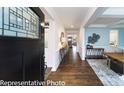 Inviting home hallway features hardwood floors, designer accents and an open floorplan at 7030 Butternut Oak Ter, Huntersville, NC 28078