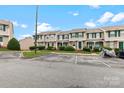 Inviting townhomes featuring green accents, well-kept lawns, and convenient parking spaces at 9606 Vinca Cir # E, Charlotte, NC 28213