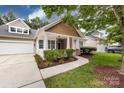 Charming home exterior showcasing a well-kept lawn, mulch flowerbeds, and inviting front entrance at 1040 Stonedown Ln, Matthews, NC 28104