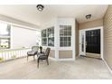 Inviting front porch with seating area, offering a relaxing outdoor space at 1040 Stonedown Ln, Matthews, NC 28104