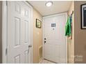 Bright entryway with tile flooring, white doors, and ample space for coats and shoes at 11069 Running Ridge Rd, Charlotte, NC 28226