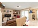 Cozy living room featuring a brick fireplace, tile floors, and sliding glass doors to the outside at 11069 Running Ridge Rd, Charlotte, NC 28226