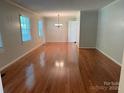 Spacious living room showcases gleaming hardwood floors and ample natural light at 1116 Fieldstone Rd, Mooresville, NC 28115
