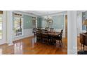 Elegant dining room featuring hardwood floors, wainscoting, and a chandelier at 1119 Williamstown Rd, Matthews, NC 28105