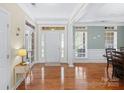 Bright foyer with hardwood floors, large windows, and a view of the front door at 1119 Williamstown Rd, Matthews, NC 28105