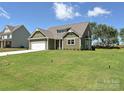 Landscaped home exterior with a well-maintained lawn and traditional architecture at 11533 Valley Oak Ln, Stanfield, NC 28163