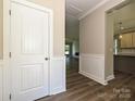 Hallway with decorative trim and wood flooring, leading into the living room at 11533 Valley Oak Ln, Stanfield, NC 28163