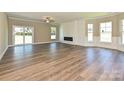 Spacious living room with wood floors, large windows and a modern fireplace at 11533 Valley Oak Ln, Stanfield, NC 28163