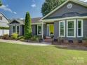 Close up of home showcasing the yellow front door and lush landscaping at 116 Hallett St, Fort Mill, SC 29715