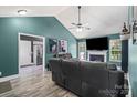 Spacious living room with vaulted ceilings, modern furnishings, and a view into the kitchen at 124 Turning Leaf Ln, Statesville, NC 28677