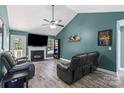 Comfortable living room with fireplace, vaulted ceilings, and a large-screen TV at 124 Turning Leaf Ln, Statesville, NC 28677