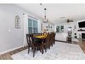 Inviting dining room with hardwood floors, a wooden table set, and plenty of natural light at 126 W Morehouse Ave, Mooresville, NC 28117