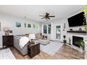 Cozy living room with a fireplace, plush seating, and wood-style flooring at 126 W Morehouse Ave, Mooresville, NC 28117