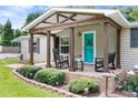 Inviting front porch with rocking chairs and manicured landscaping, perfect for enjoying peaceful moments outdoors at 1489 L R Schronce Ln, Iron Station, NC 28080