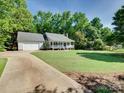 Exterior view of home with front porch, large front lawn and mature shade trees at 1529 Covenant Pl, Rock Hill, SC 29732