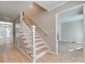 Inviting foyer with hardwood floors and a staircase with a white railing at 1529 Covenant Pl, Rock Hill, SC 29732