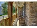 Inviting front porch featuring stone accents and wicker chairs, perfect for relaxing at 17537 Caddy Ct, Charlotte, NC 28278