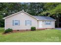 Charming single-story home featuring light siding, blue shutters, and a well-maintained lawn at 201 Killian Cir, Clover, SC 29710