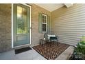 Inviting front porch area with seating, a decorative rug, and stylish glass door at 231 Cotton Ridge Pl, Rock Hill, SC 29730
