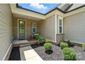 Inviting front porch with manicured landscaping and a glass door, showcasing the entrance to the home at 231 Cotton Ridge Pl, Rock Hill, SC 29730