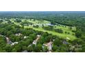 Scenic aerial view of property nestled among mature trees near golf course and community pool at 3304 Chilham Pl, Charlotte, NC 28226
