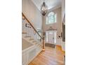 Grand two-story foyer features hardwood floors, chandelier, and elegant staircase at 413 Farm Branch Dr, Fort Mill, SC 29715