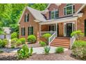 A charming brick home displays meticulous landscaping and an inviting entrance at 413 Farm Branch Dr, Fort Mill, SC 29715