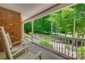Relax on this covered porch with views of the lush and tree-lined surroundings at 413 Farm Branch Dr, Fort Mill, SC 29715