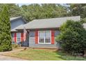 Inviting single-story home with red shutters, well-manicured lawn, and lovely landscaping at 432 English Ivy Ct, Fort Mill, SC 29715