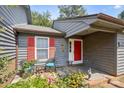 Cozy front porch with seating, colorful flowers, and charming exterior details at 432 English Ivy Ct, Fort Mill, SC 29715