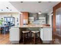 Well-appointed kitchen with a center island with seating and stainless steel appliances, perfect for cooking at 435 S Tryon St # 907, Charlotte, NC 28202