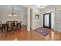 Spacious foyer flowing into a dining area, featuring hardwood floors and decorative lighting at 4527 Hubbard Falls Dr, Charlotte, NC 28269