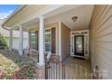 Inviting front porch with classic columns and decorative windows, offering a warm welcome to the home at 4527 Hubbard Falls Dr, Charlotte, NC 28269