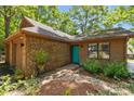 Inviting home showcasing a brick exterior, turquoise front door, and tasteful landscaping at 498 Glory Ct, Fort Mill, SC 29715