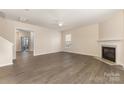 Bright living room featuring a cozy fireplace and modern flooring at 5307 Ayers Orchard Way, Charlotte, NC 28227