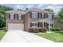 Charming brick home with a two-car garage and well-maintained landscaping at 704 Millstream Dr, Rock Hill, SC 29732