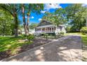 Beautifully landscaped home with a long driveway and classic architectural details at 716 W Graham St, Shelby, NC 28150